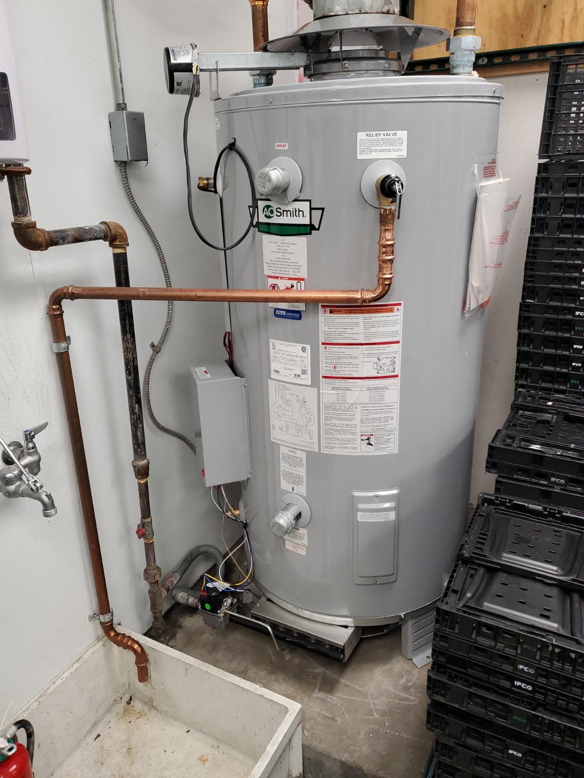 Commercial plumber in Evansville, IN — A.O. Smith gas water heater piped beside a mop sink