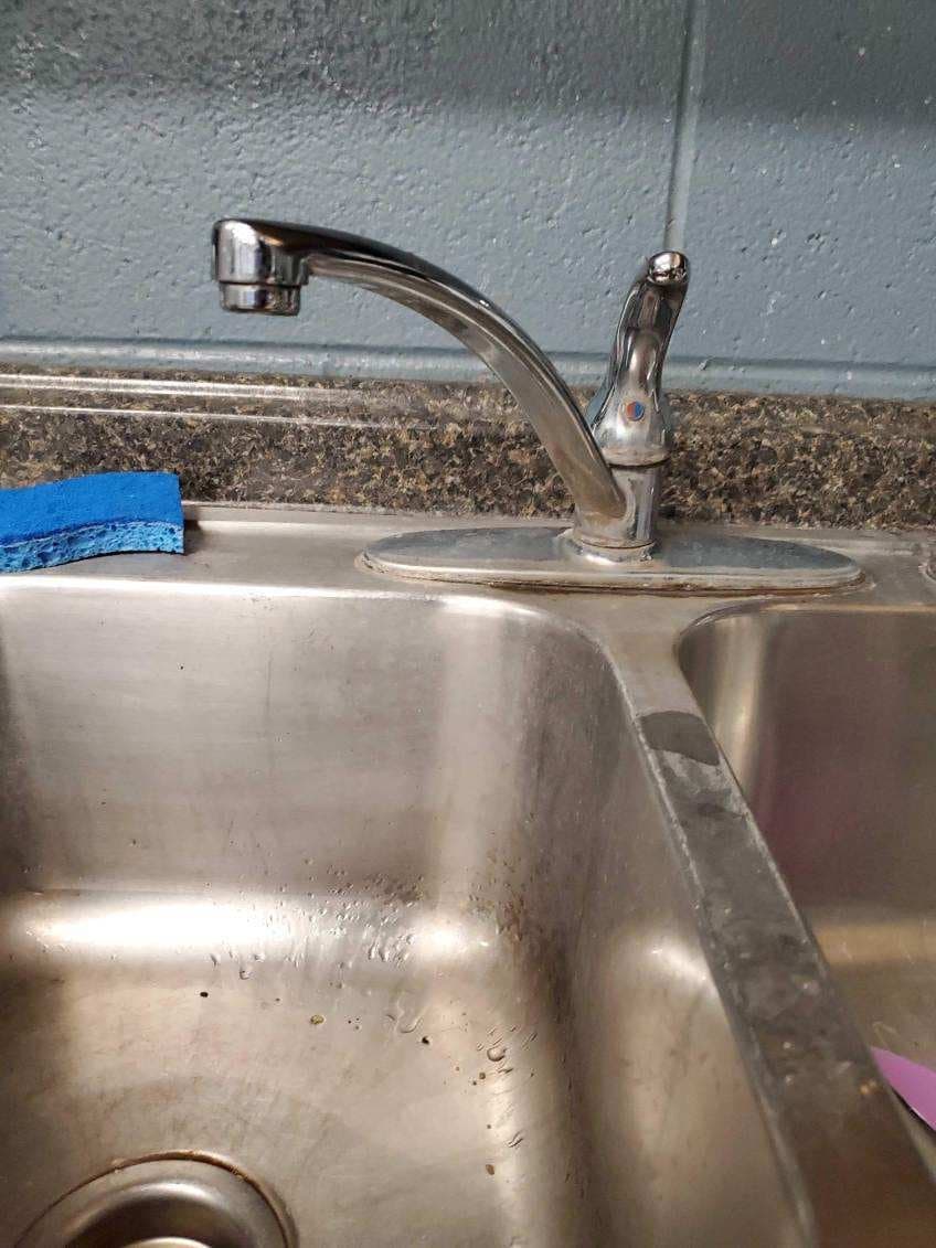 Commercial fixture repair in Evansville, IN — chrome gooseneck faucet on a stainless commercial sink