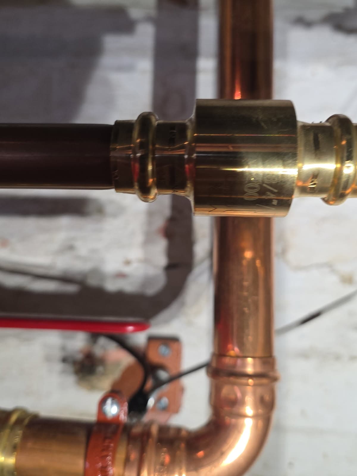 Plumbing repair in Evansville, IN — copper pipe joined with a brass press-fit coupling