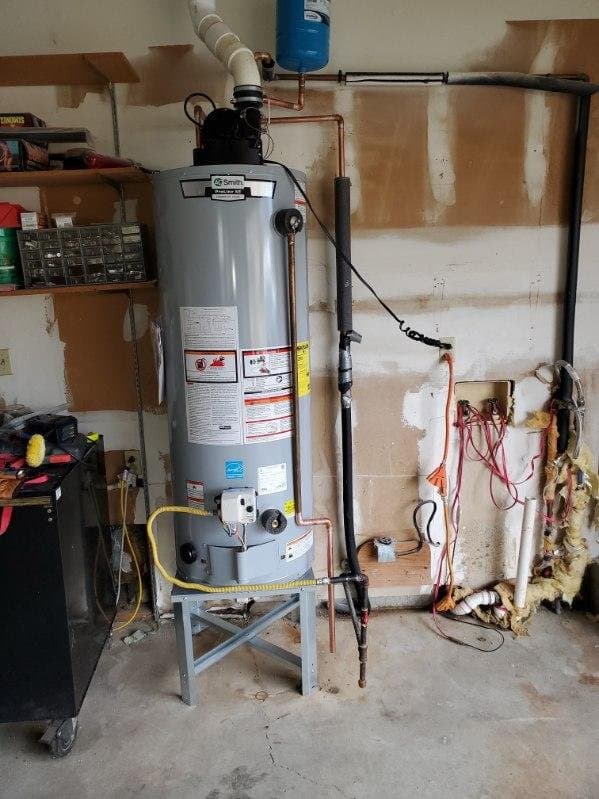Water tank installation in Evansville, IN — garage A.O. Smith water heater with a blue expansion tank on the line above it