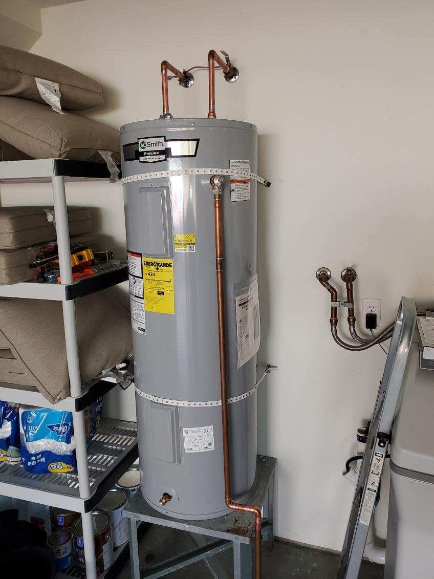 Water tank repair in Evansville, IN — A.O. Smith ProLine tank with copper lines in a laundry room