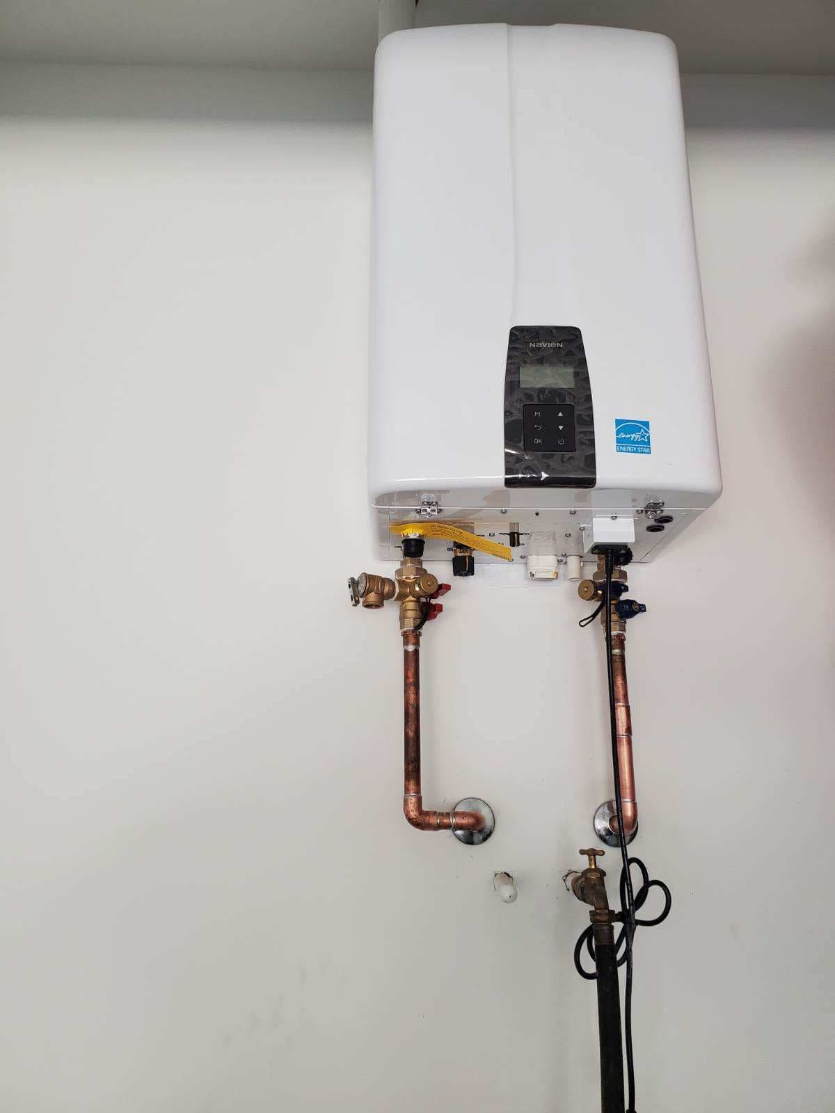 Plumber in Evansville, IN — Navien tankless water heater with copper pipes and brass valves