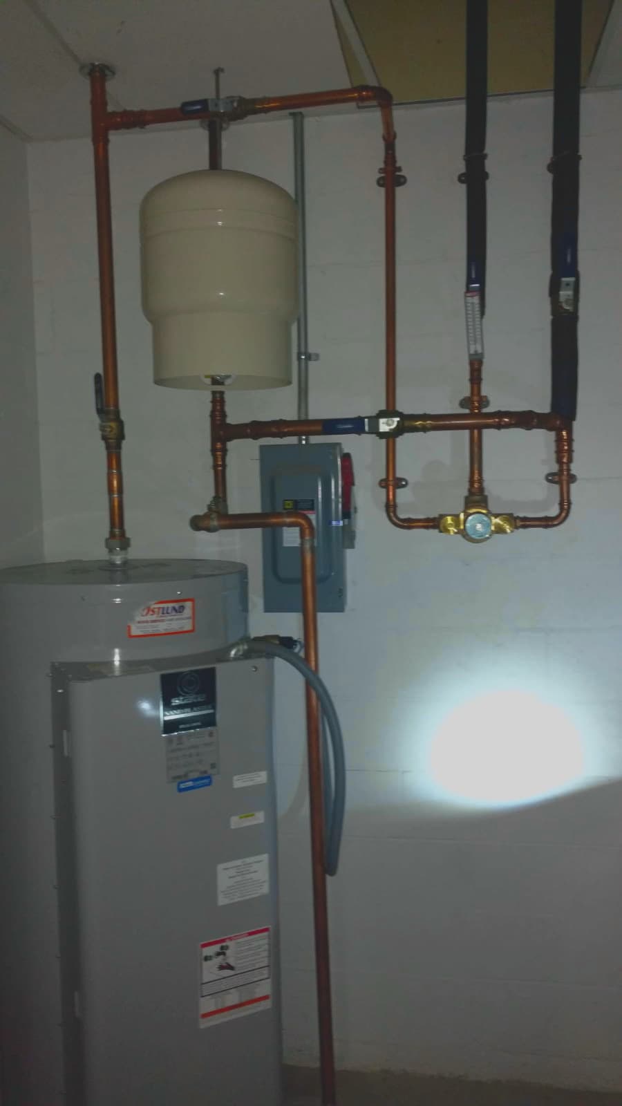 Plumbing repair in Evansville, IN — tank water heater with expansion tank and copper piping